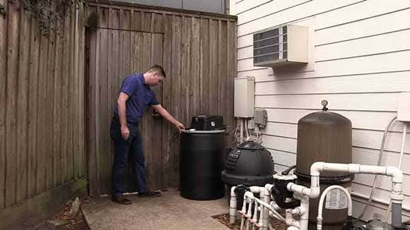 Home Owner inspects DIY Misting Unit for mosquito control